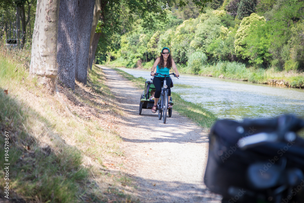 Fototapeta premium Woman riding with a toddler