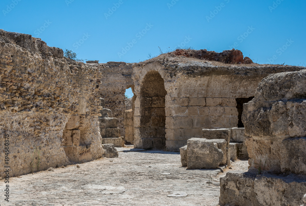 The arch in the stone wall of Sandstone. Ancient masonry. The Ruins Of Carthage In Tunisia