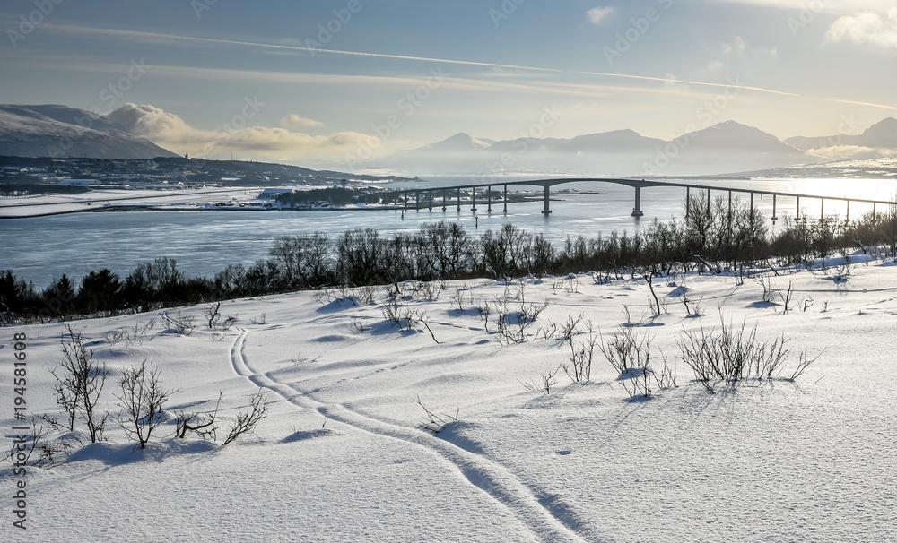 View of Tromsø ( Tromso ) with Sandnessundbrua ( Kvaløybrua ) from Kvaløya during winter with a lot of snow, Norway