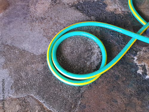 Colorful Green Watering Hose On the Floor