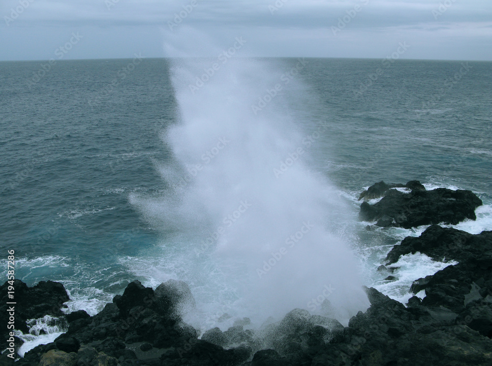 Saint Leu / La Reunion: Le Souffleur is a natural phenomenon on the wild rocky coast caused by the repeated onslaught of the sea swell with an impressive jet of sea-spray