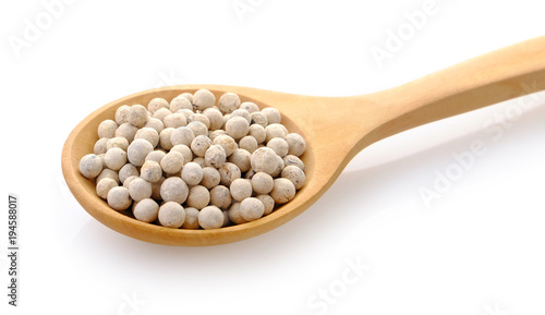 Pepper seeds in wooden spoon