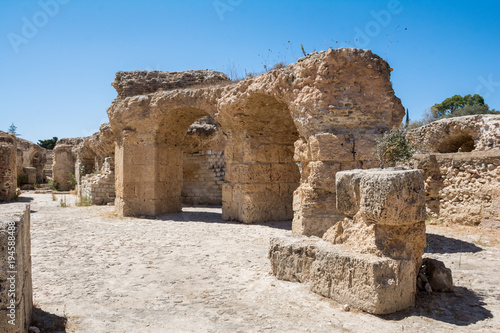 The arch in the stone wall of Sandstone. Ancient masonry. The Ruins Of Carthage In Tunisia