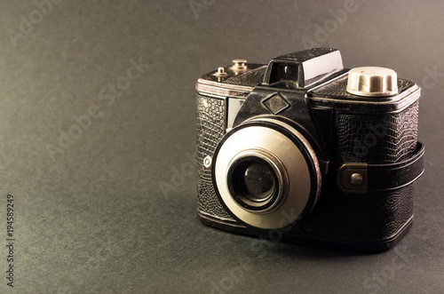 Retro film camera isolated on grey background