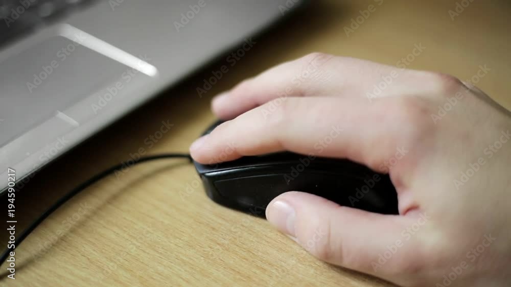Hand of young caucasian man clicking and scrolling mouse Hand of young caucasian man clicking and scrolling mouse