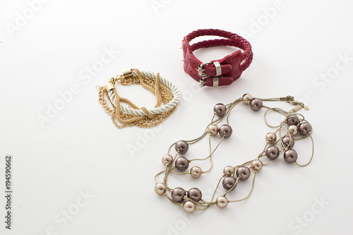 Jewelry, bracelets, beads, watches, key rings on white background