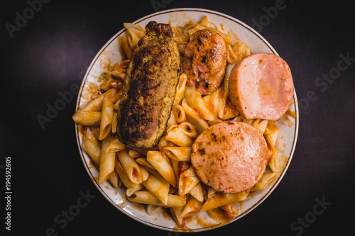 fatty food in a plate on a black background photo