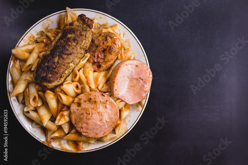 fatty food in a plate on a black background photo