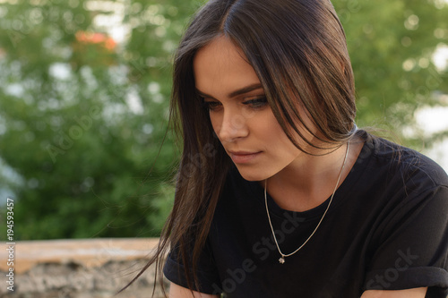 Portrait of a beautiful young girl with long dark hair, evening make-up.