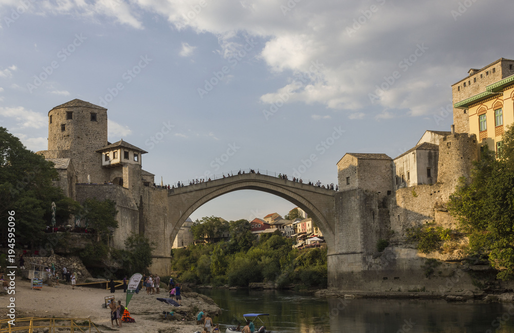People on the small beach under the famous Stari Most bridge in Mostar