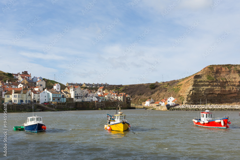 Fototapeta premium Staithes Yorkshire uk boats in harbour in seaside town and tourist destination