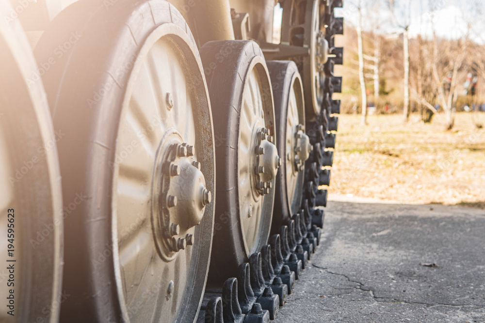 Caterpillar of a military tank standing in a park.