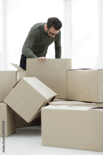 man examining the box in the new house