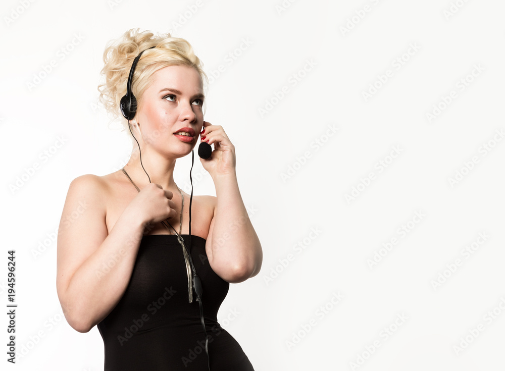 Sexy smiling woman working in a call center. Headset telemarketing woman talking on helpline. free space for your text Sexy smiling woman working in a call center. Headset telemarketing woman talking on helpline. free space for your text