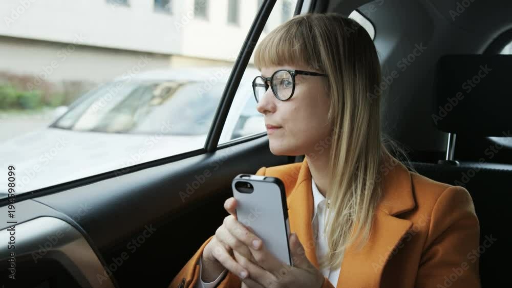 Woman Holding a Mobile and Looking Through the Window Woman Holding a Mobile and Looking Through the Window