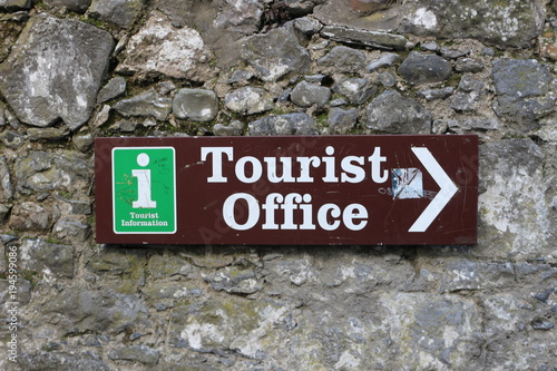 Metallic signpost indicating the direction of the tourist office