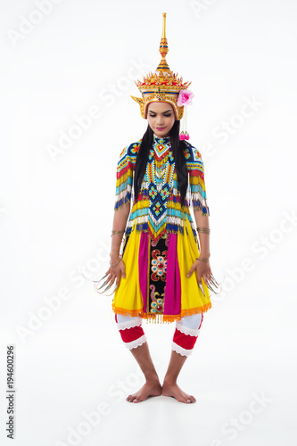 The lady in SThe lady in colorful Southern thai classical dancing suit is posing Thai southern dance pattern on white background.outhern thai classical dancing suit is posing on white background.