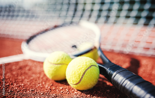 Tennis ball with racket on the tennis court. Sport, recreation concept photo