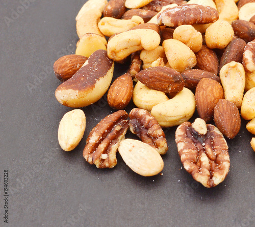Mix nuts, dry fruits and chocolate on black background