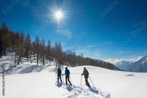 Three girls have fun on a snowshoe hike