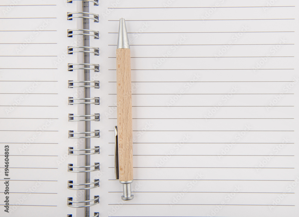 Opened notepad with wooden pen Opened notepad with wooden pen