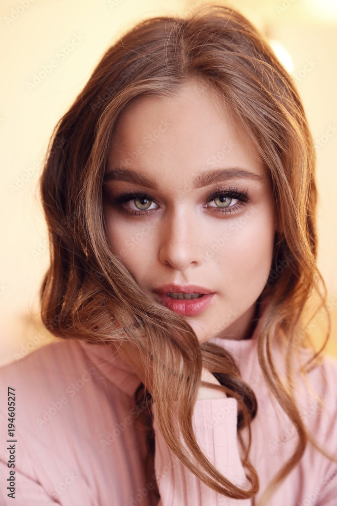 Naklejka premium beautiful young woman with natural hair and makeup in casual clothes