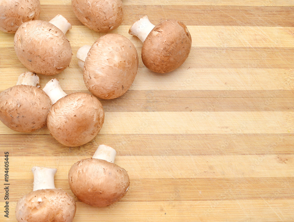 fresh mushroom champignon isolated on wooden board fresh mushroom champignon isolated on wooden board