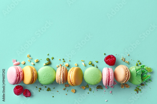 Colorful french macarons on blue background photo