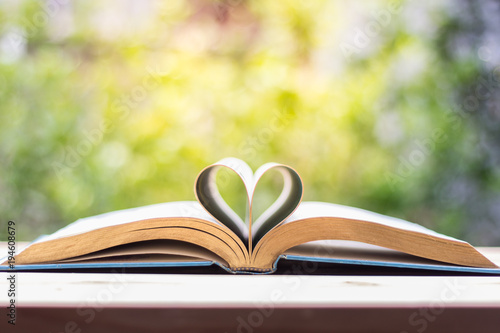 Book of love Heart shaped at the book with a blurry background.
