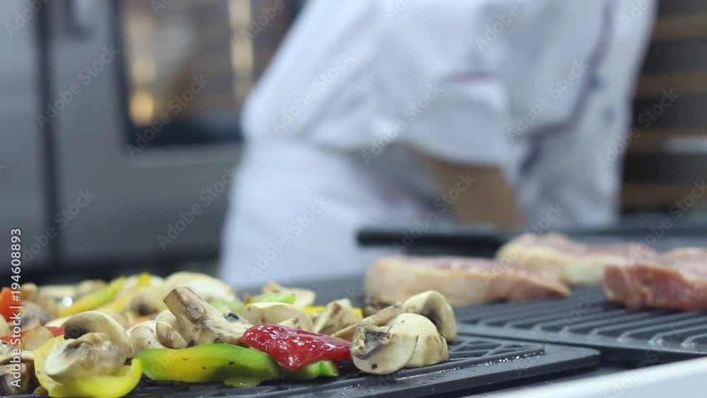 Professional chef preparing a pizza in a modern Italian restaurant. Professional chefs work in a modern kitchen with fresh meat and vegetables. Professional chef preparing a pizza in a modern Italian restaurant. Professional chefs work in a modern kitchen with fresh meat and vegetables.
