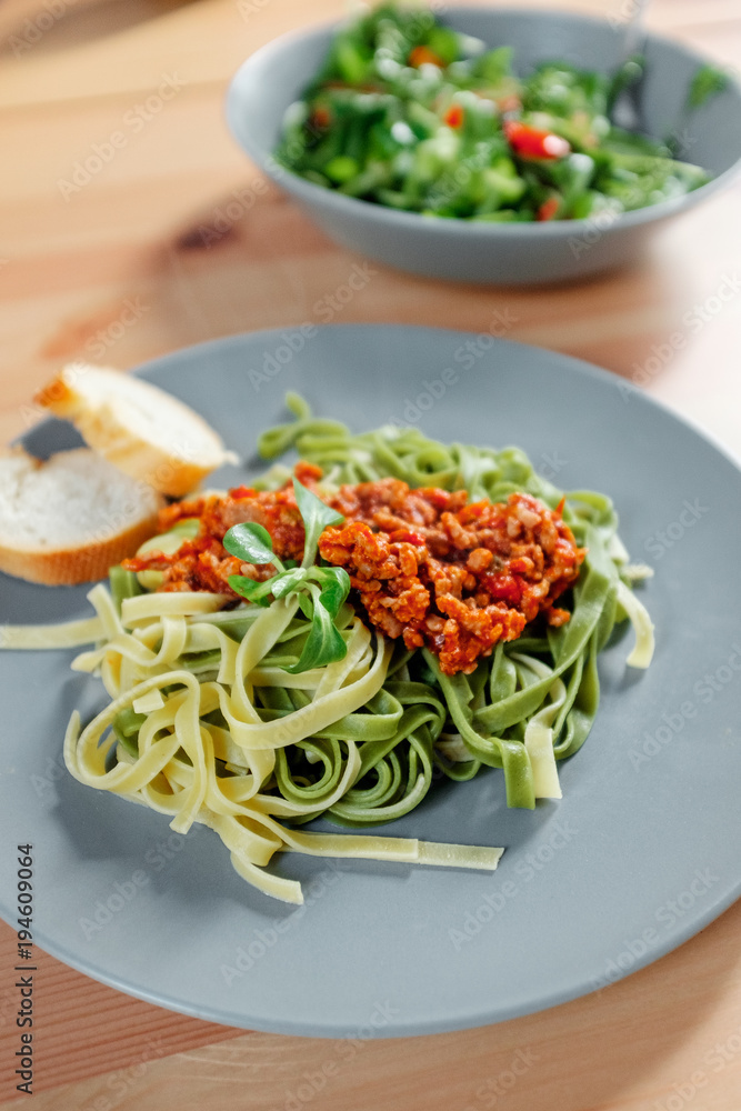Fetuchini pasta with beef tomato sauce on wood table , italian food
