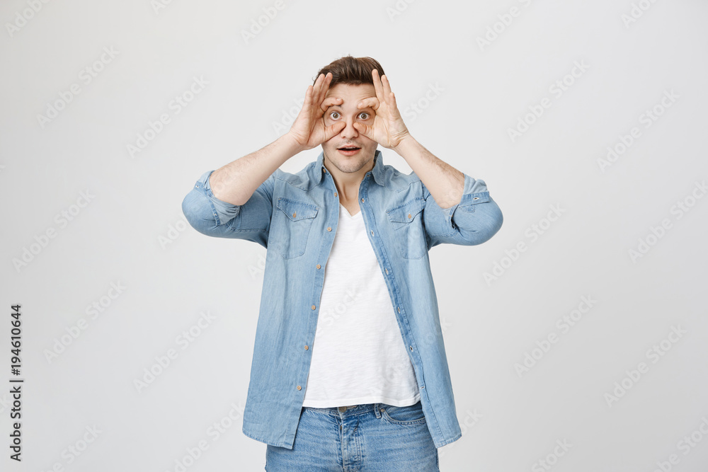 Portrait of man who widely opens his eyes using hands with surprised and amazed expression, isolated over white background. Person can't believe what he sees. Guy is tired after long night partying Portrait of man who widely opens his eyes using hands with surprised and amazed expression, isolated over white background. Person can't believe what he sees. Guy is tired after long night partying