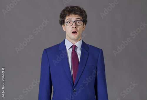 Guy in blue suit shoking