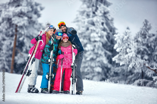 Family on ski holiday in mountains enjoying and have fun