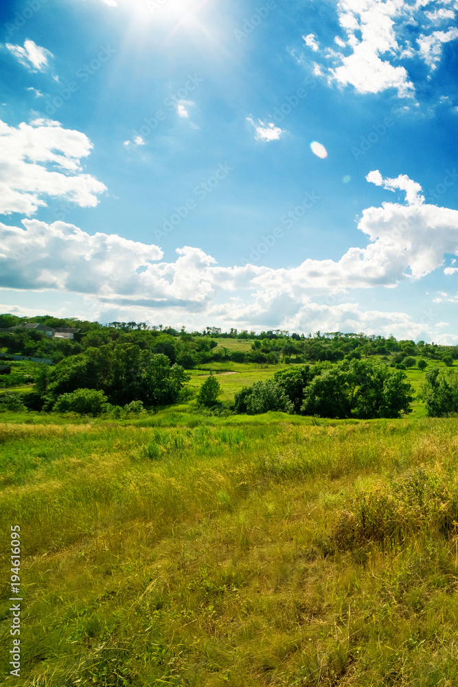 a summer landscape of rolling hills with beautiful clouds a summer landscape of rolling hills with beautiful clouds