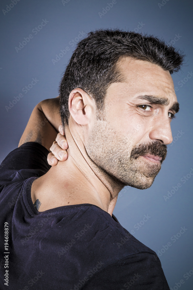 Obraz premium Young handsome man having neck problems