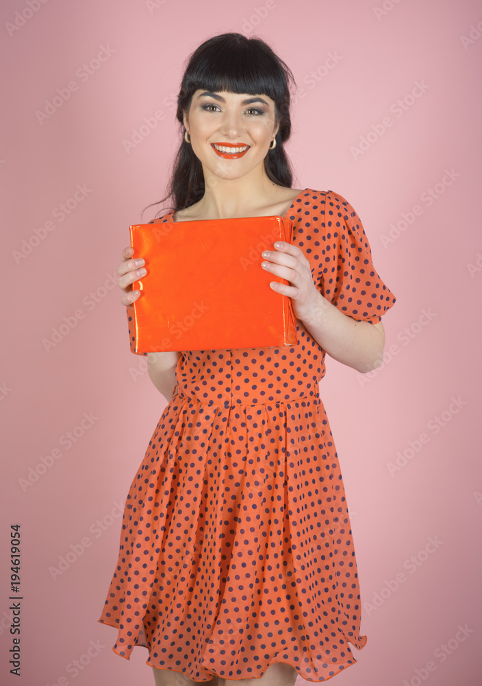 Attractive woman with makeup holds red box or gift. Attractive woman with makeup holds red box or gift.