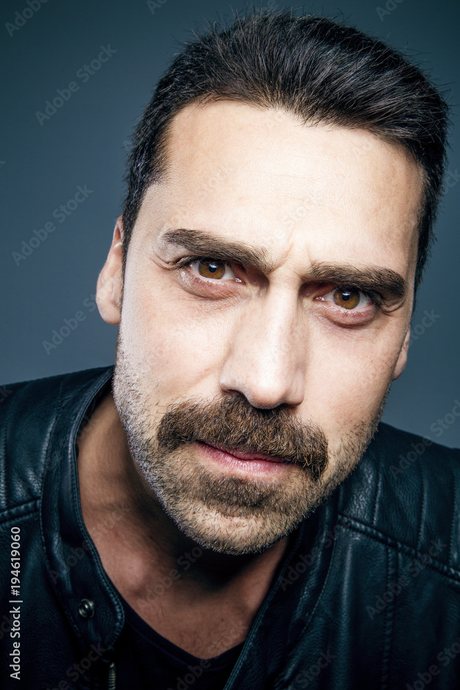 Young handsome man with beard and mustache studio portrait Young handsome man with beard and mustache studio portrait