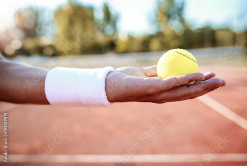 Tennis. Player holding ball in his hand. Sport, recreation concept © bobex73