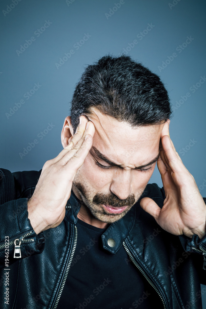 Young handsome man suffering from headache Young handsome man suffering from headache
