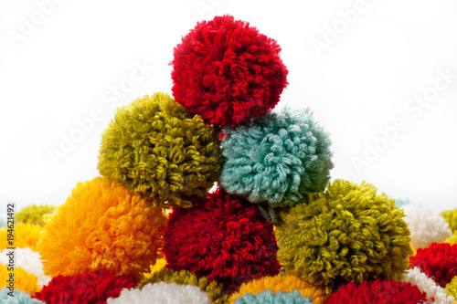 Mat of pompons made from multi-colored handmade yarn