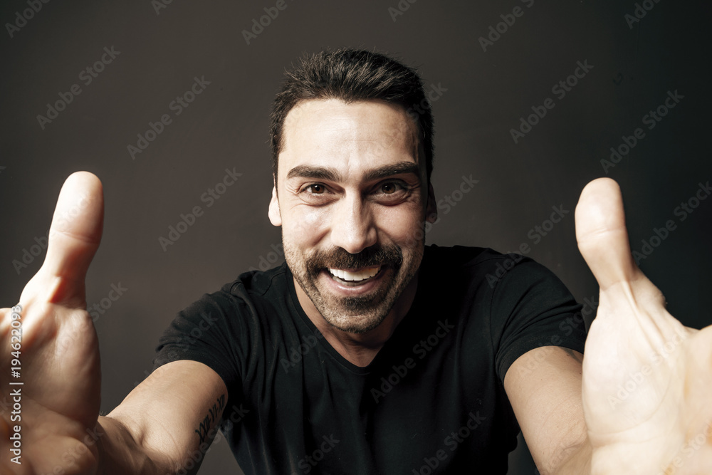 Naklejka premium Young handsome man with beard and mustache studio portrait