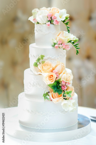 beautiful multi-tiered wedding cake decorated with fresh flowers