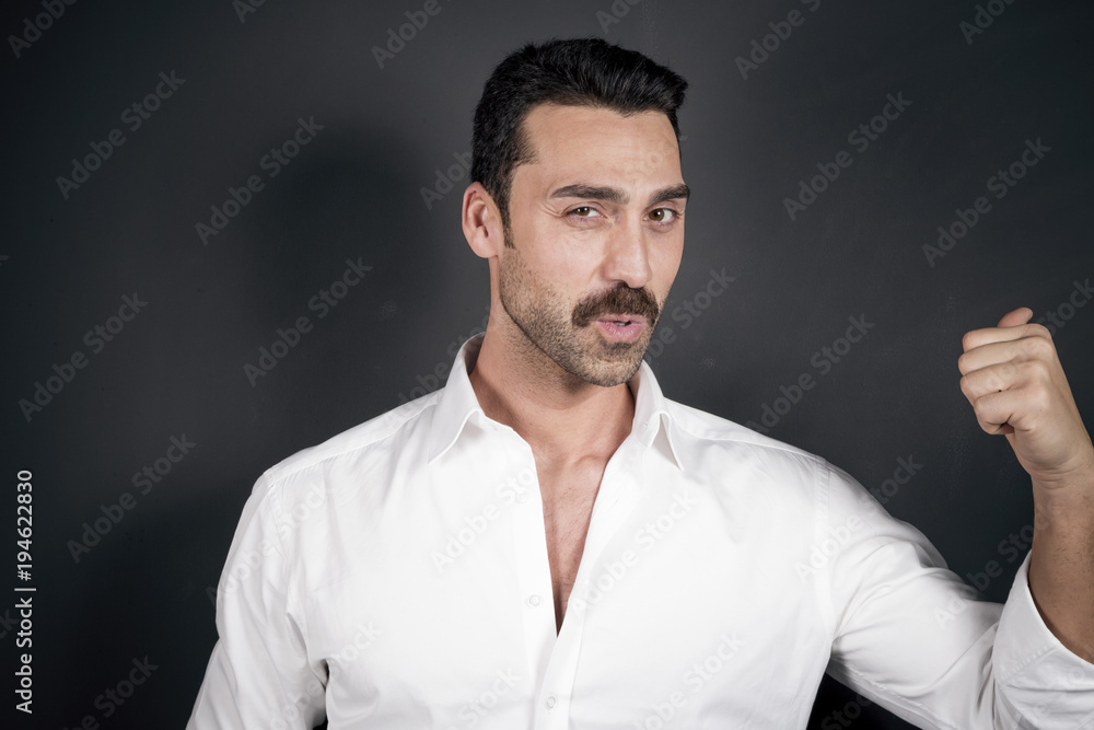 Young handsome man with beard and mustache studio portrait