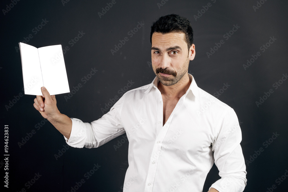 Young man in white shirt reading a booklet