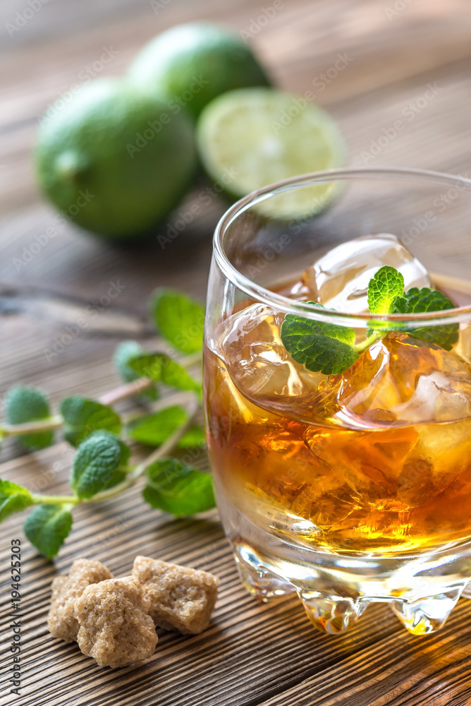 Glass of rum on the wooden background Glass of rum on the wooden background