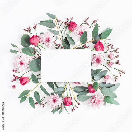 Flowers composition. Paper blank, various pink flowers and eucalyptus branches on white background. Flat lay, top view, square, copy space