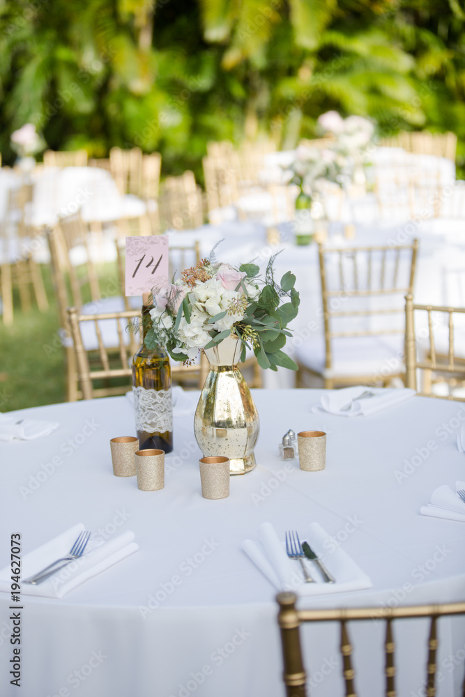 Gold and White Table Decor with Bouquet of Flowers and Wine Bottle Table Number Sign