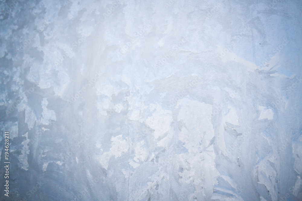 Winter frosty patterns on the frozen ice window Winter frosty patterns on the frozen ice window
