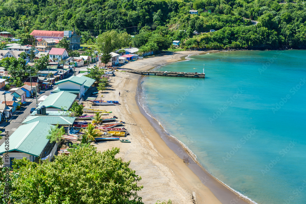 Fototapeta premium Anse la Raye - tropical beach on the Caribbean island of St. Lucia. It is a paradise destination with a white sand beach and turquoiuse sea.